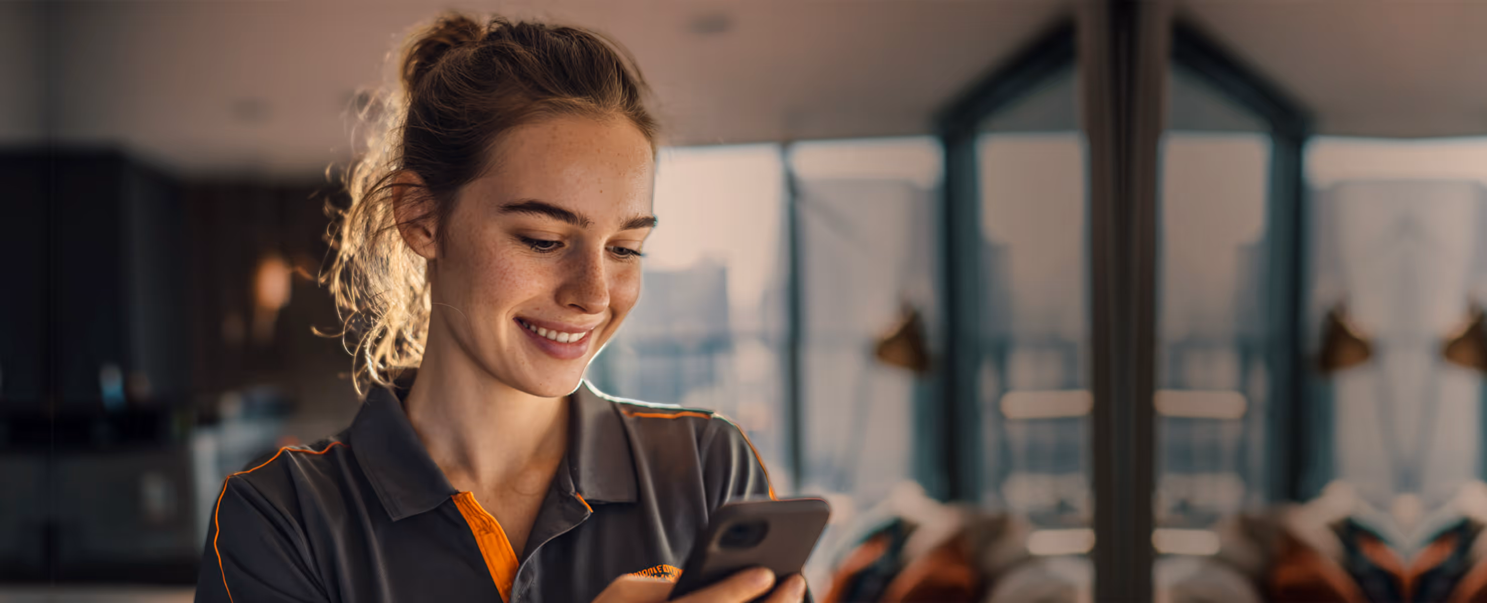 Happy housekeeper using Tasa, a picture-based app for housekeeping